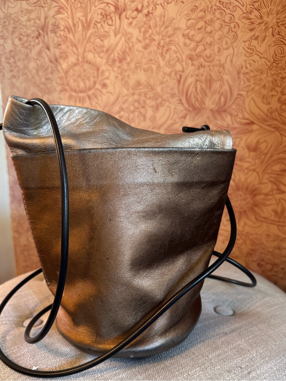 Carol Risley Metalic soft leather Round bag with crossbody strap. Gold bronze